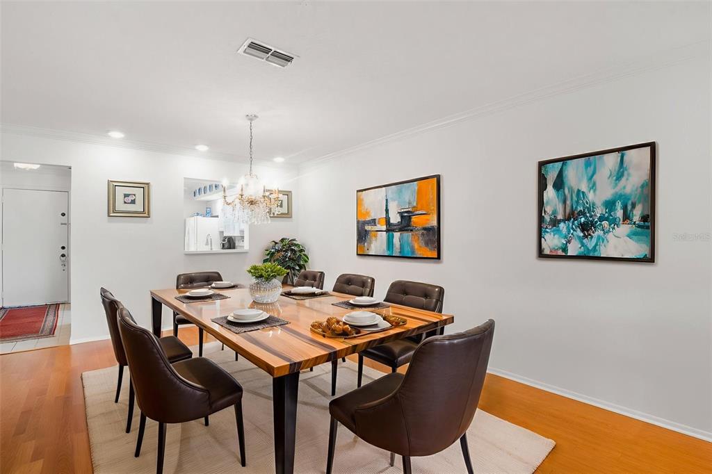1012 Dunrobin Drive, Unit D Palm Harbor, FL 34684 - Photo 20 of 61 a view of a dining room with furniture and chandelier