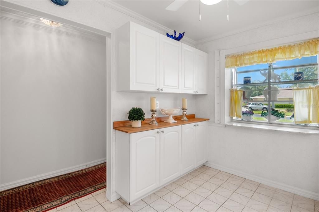 1012 Dunrobin Drive, Unit D Palm Harbor, FL 34684 - Photo 26 of 61 a room with granite countertop white cabinets and white appliances