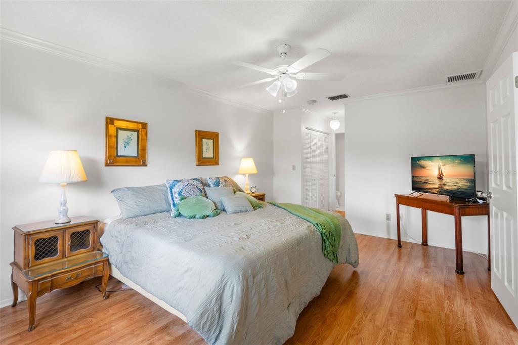 1012 Dunrobin Drive, Unit D Palm Harbor, FL 34684 - Photo 28 of 61 a bedroom with a bed and a lamp on table