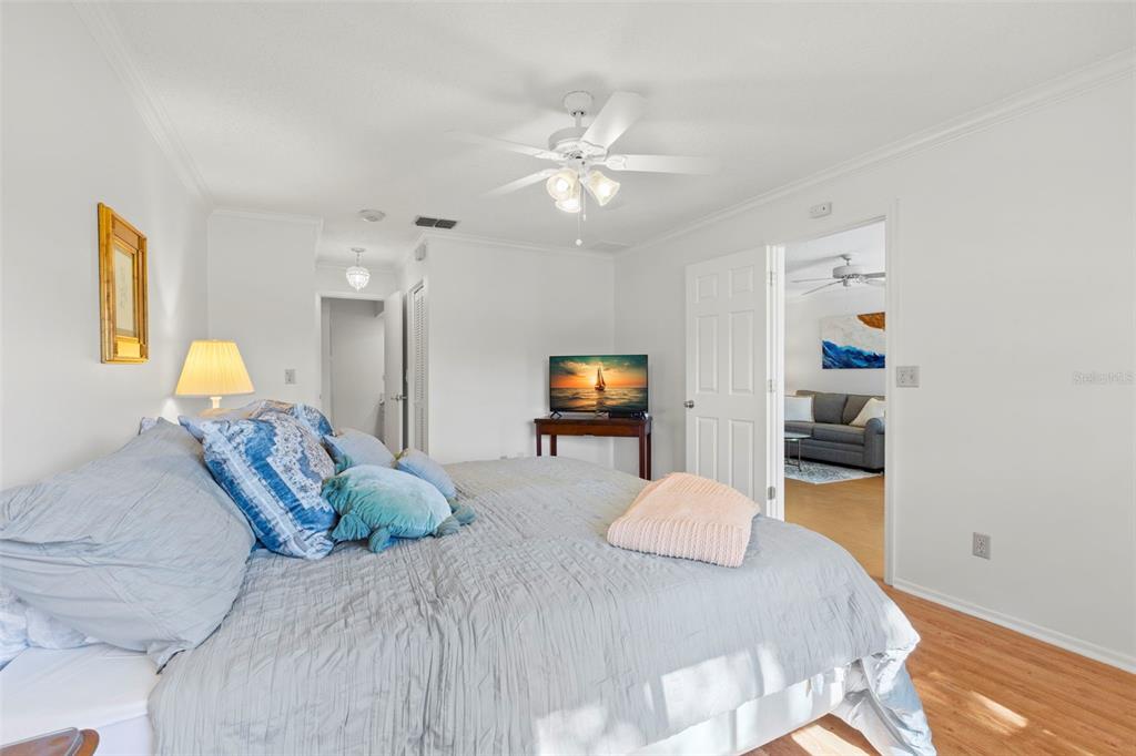 1012 Dunrobin Drive, Unit D Palm Harbor, FL 34684 - Photo 30 of 61 a bedroom with a bed and a lamp