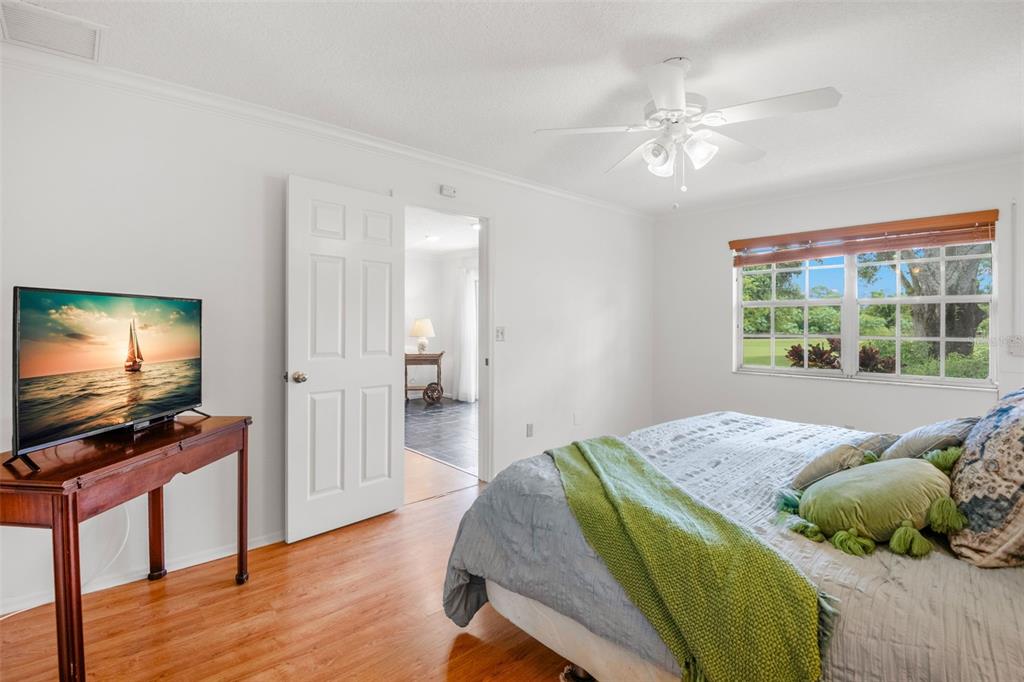 1012 Dunrobin Drive, Unit D Palm Harbor, FL 34684 - Photo 31 of 61 a bedroom with a bed and flat screen tv