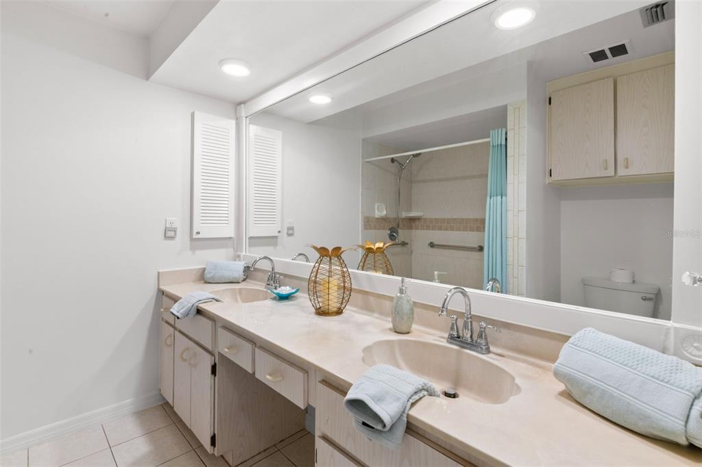 1012 Dunrobin Drive, Unit D Palm Harbor, FL 34684 - Photo 32 of 61 a bathroom with a granite countertop sink mirror and double