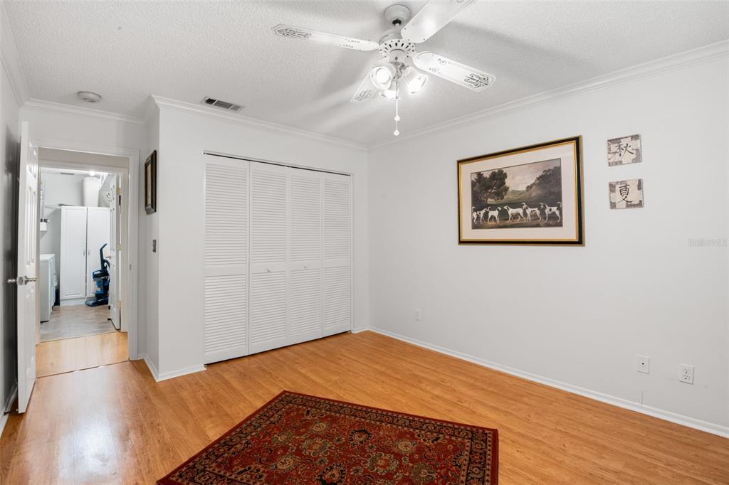 1012 Dunrobin Drive, Unit D Palm Harbor, FL 34684 - Photo 36 of 61 a view of a room with wooden floor and ceiling fan