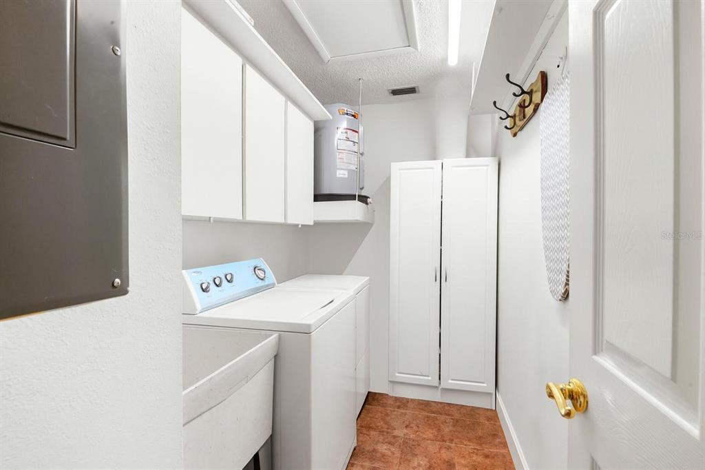 1012 Dunrobin Drive, Unit D Palm Harbor, FL 34684 - Photo 38 of 61 a utility room with dryer and washer