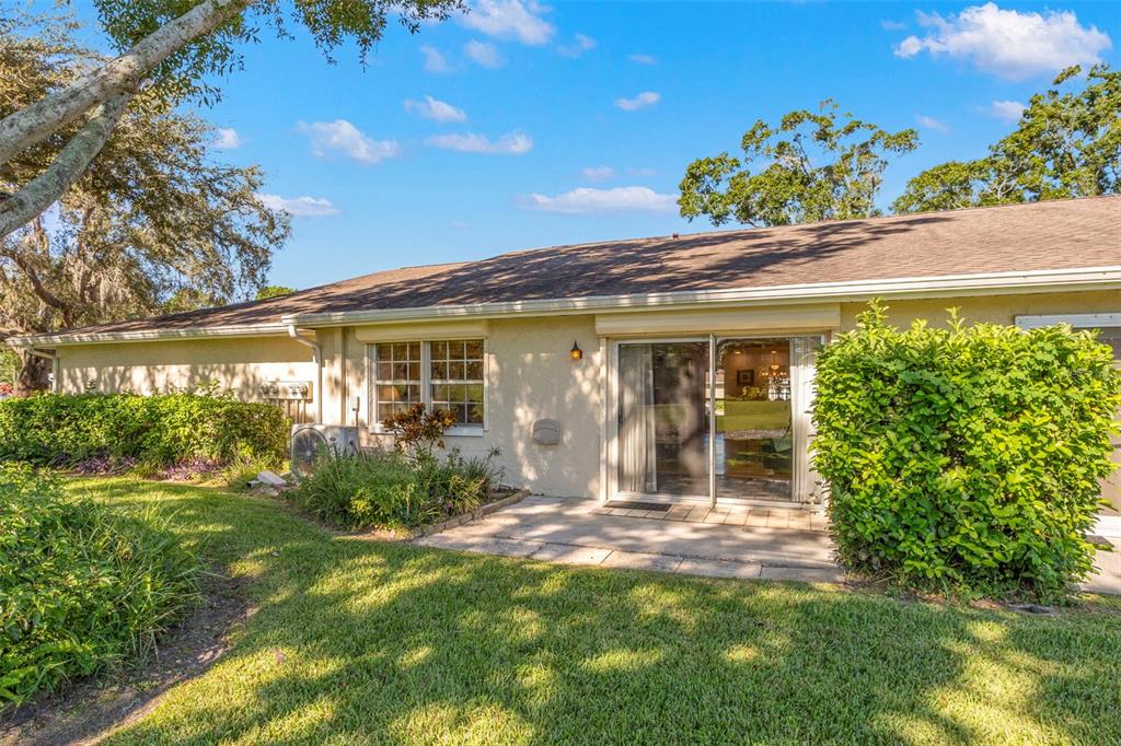 1012 Dunrobin Drive, Unit D Palm Harbor, FL 34684 - Photo 7 of 61 a front view of a house with garden