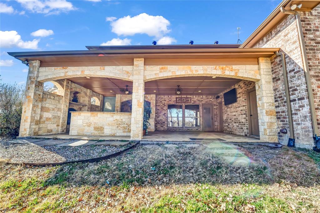 116 McClintock Court Weatherford, TX 76088 - Photo 5 of 38 Patio with fireplace and kitchen