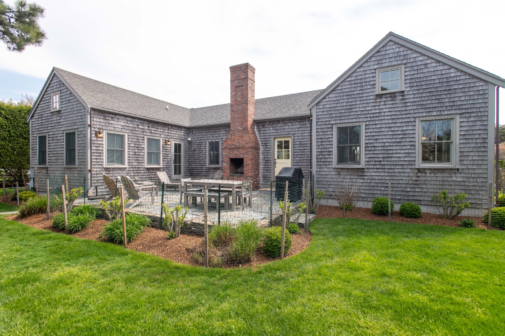 146 Surfside Road Nantucket, MA 02554 - Photo 39 of 43 a view of a house with a backyard and a patio