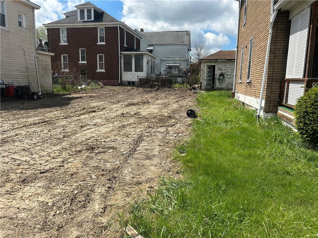 727 South 14th Street Monessen, PA 15062 - Photo 3 of 13 a view of a brick house with a yard