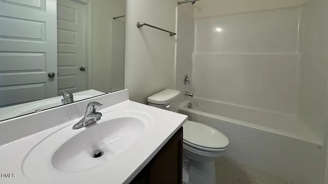 a kitchen with stainless steel appliances granite countertop a refrigerator a sink a stove and a refrigerator with wooden cabinets