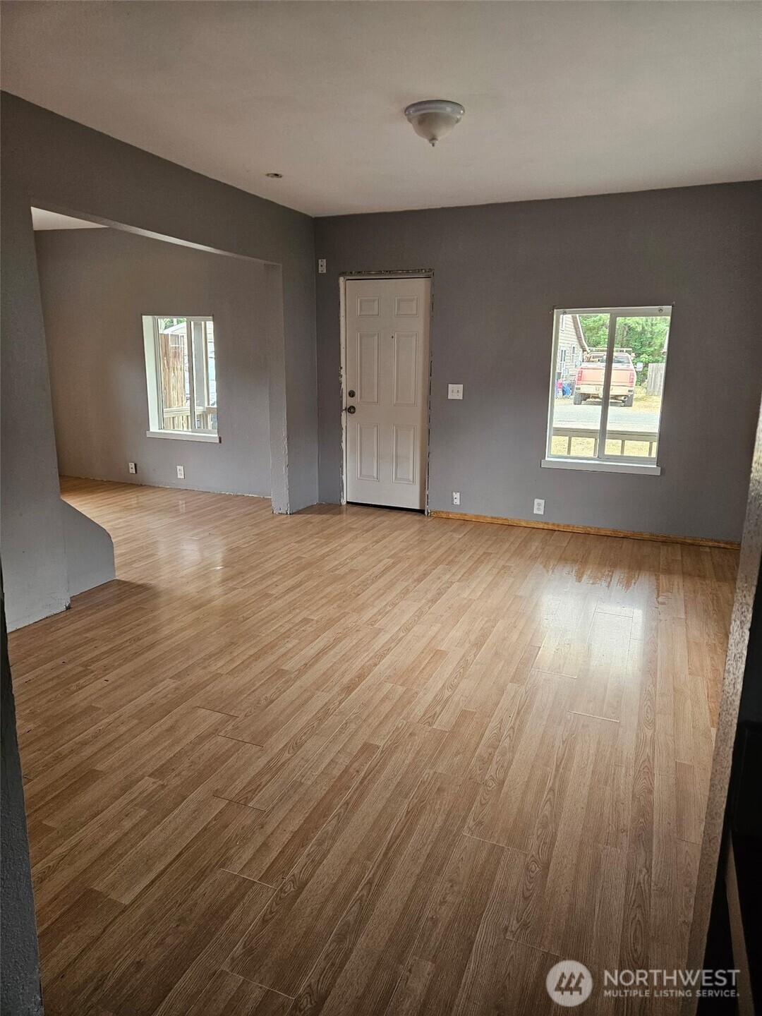 906 Southwest Mayer Street Winlock, WA 98596 - Photo 2 of 16 an empty room with wooden floor and windows