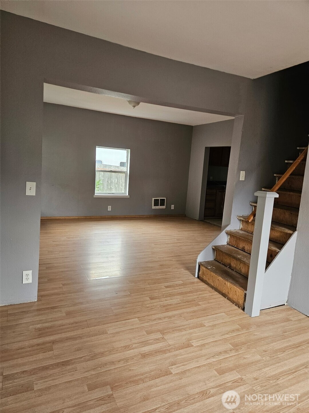 906 Southwest Mayer Street Winlock, WA 98596 - Photo 3 of 16 a view of an empty room with wooden floor and a window
