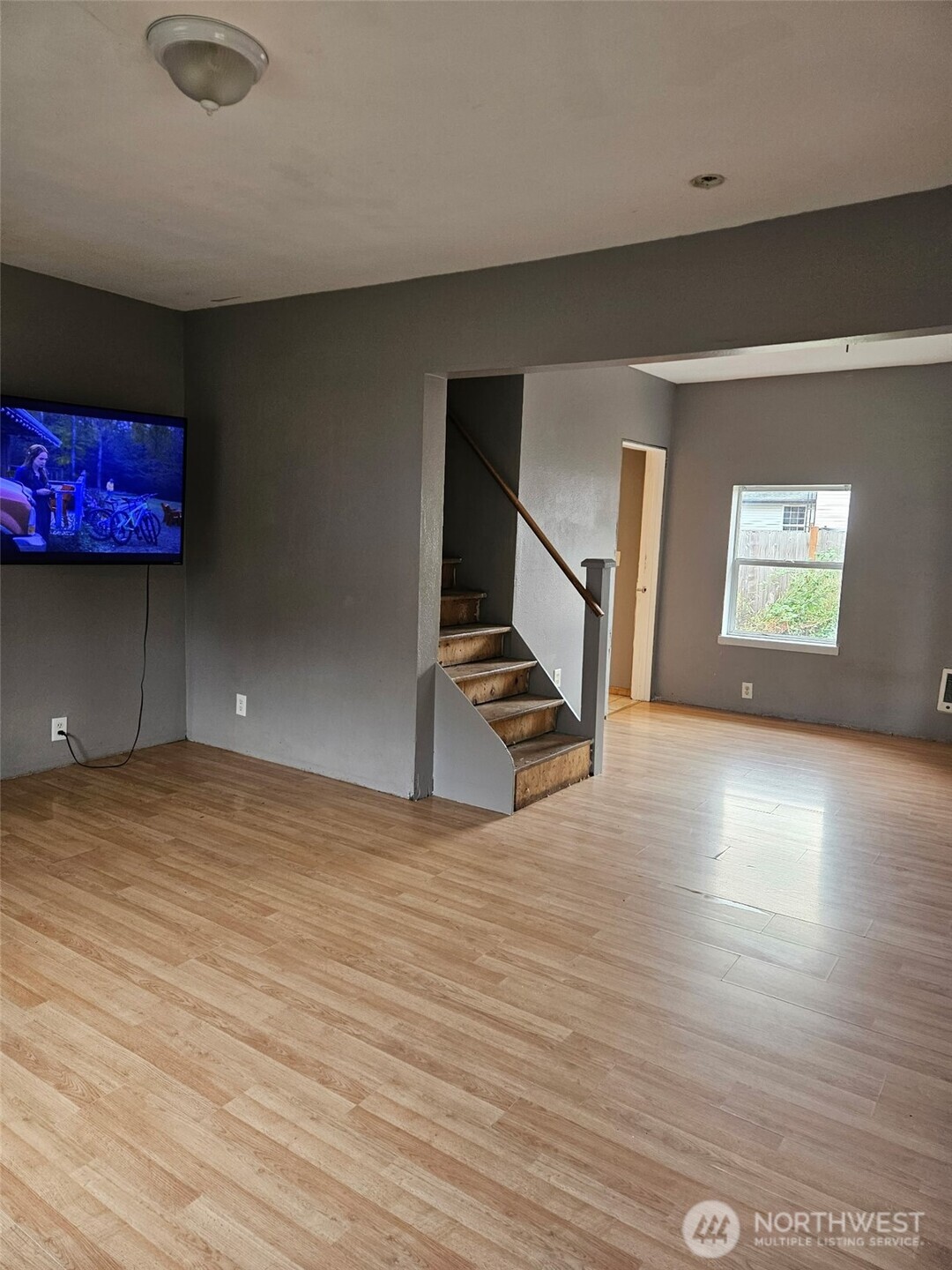 906 Southwest Mayer Street Winlock, WA 98596 - Photo 4 of 16 a view of an empty room with window and wooden floor
