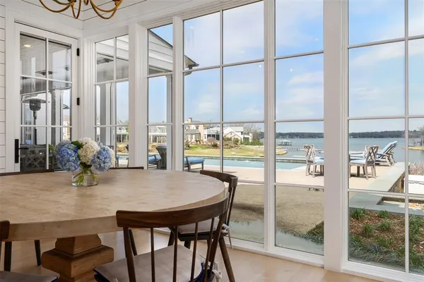 a dining room with furniture and a floor to ceiling window