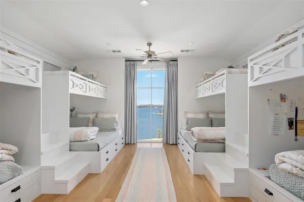 a bedroom with a bed couch and a large window