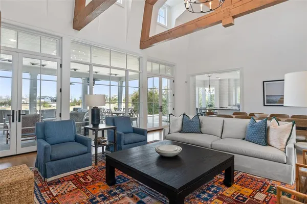 a living room with furniture wooden floor and a large window