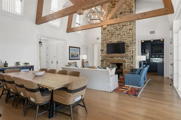 a view of a dining room with furniture wooden floor and a fireplace