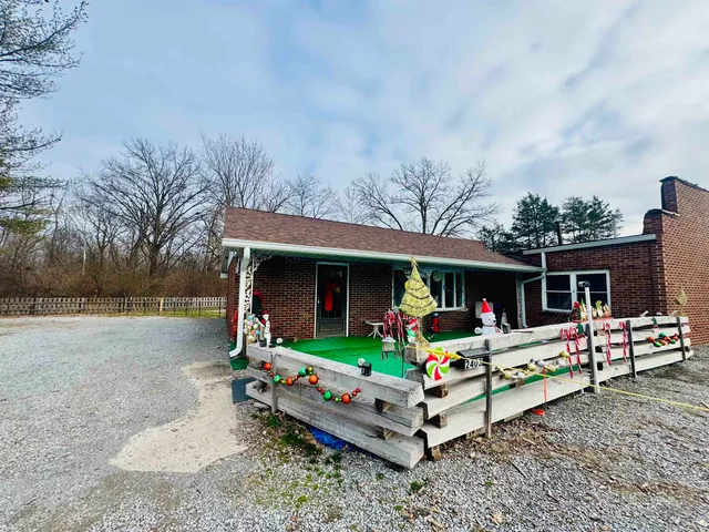 a front view of house with swing and slide
