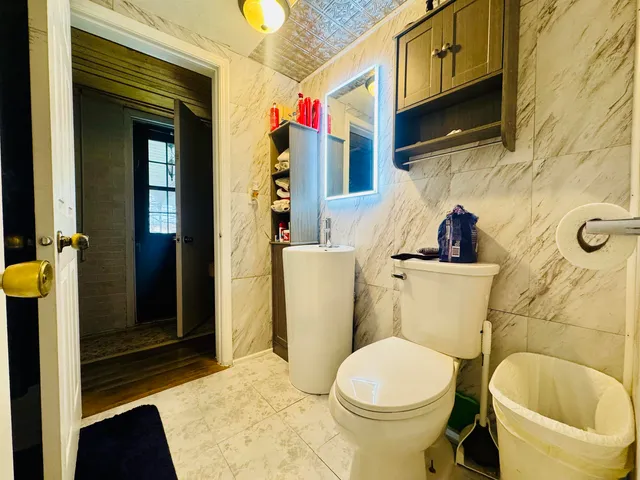 a bathroom with a sink toilet and shower