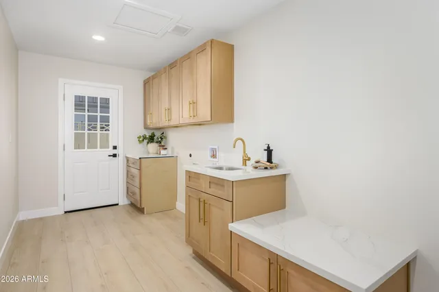 a utility room with a sink washer and dryer