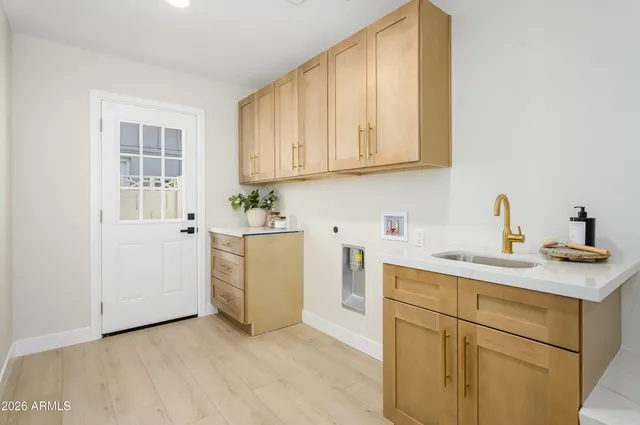 a view of a kitchen with sink and cabinets