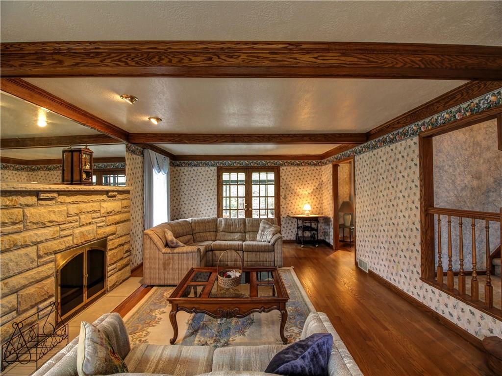 185 Thompson Road Beaver Falls, PA 15010 - Photo 10 of 25 Beamed Family Room has one of the two gas fireplaces, recessed lighting, beautiful hardwood floors and opens to enclosed patio.