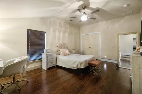 a spacious bedroom with a bed and a chandelier