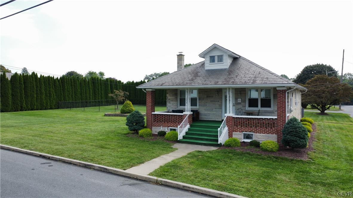 103 Fairview Avenue Wind Gap, PA 18091 - Photo 20 of 22 a front view of a house with garden and porch