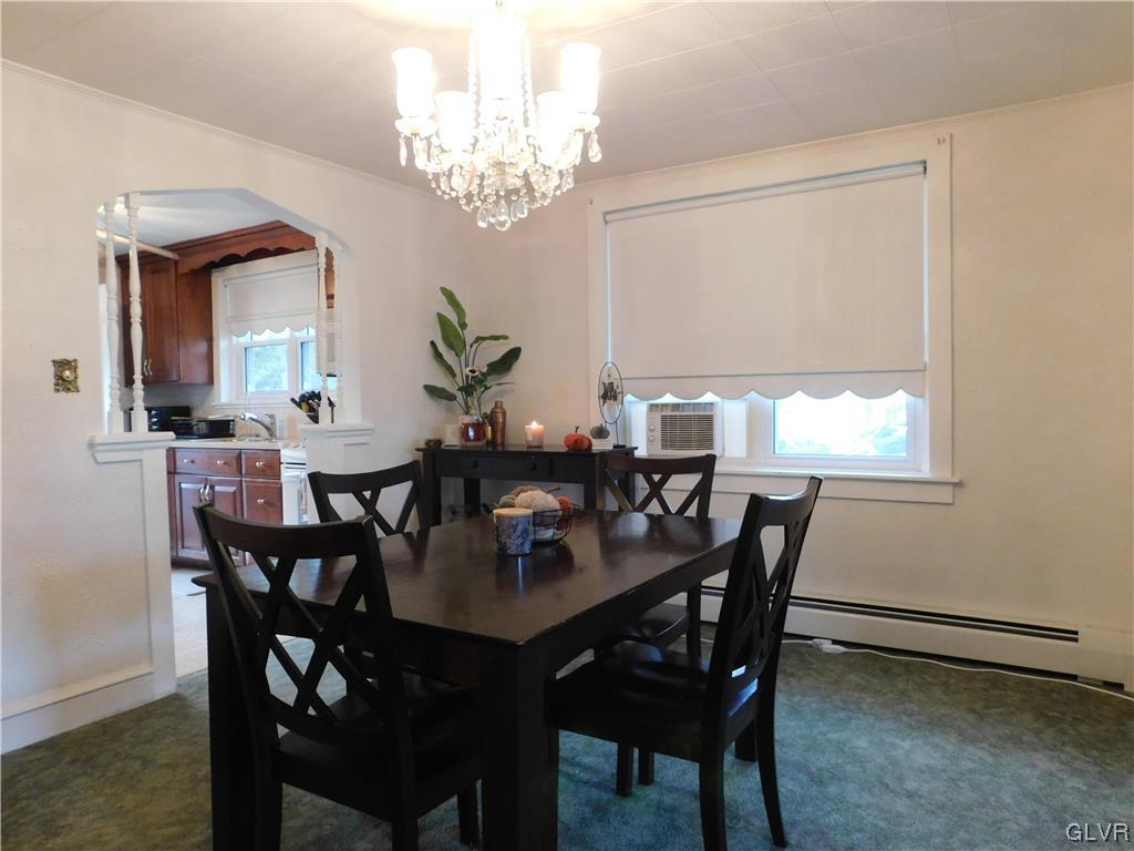 103 Fairview Avenue Wind Gap, PA 18091 - Photo 5 of 22 a view of a dining room with furniture a chandelier and wooden floor