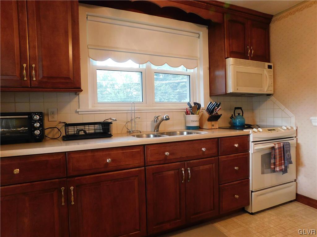103 Fairview Avenue Wind Gap, PA 18091 - Photo 6 of 22 a kitchen with stainless steel appliances granite countertop wooden cabinets a sink and a stove