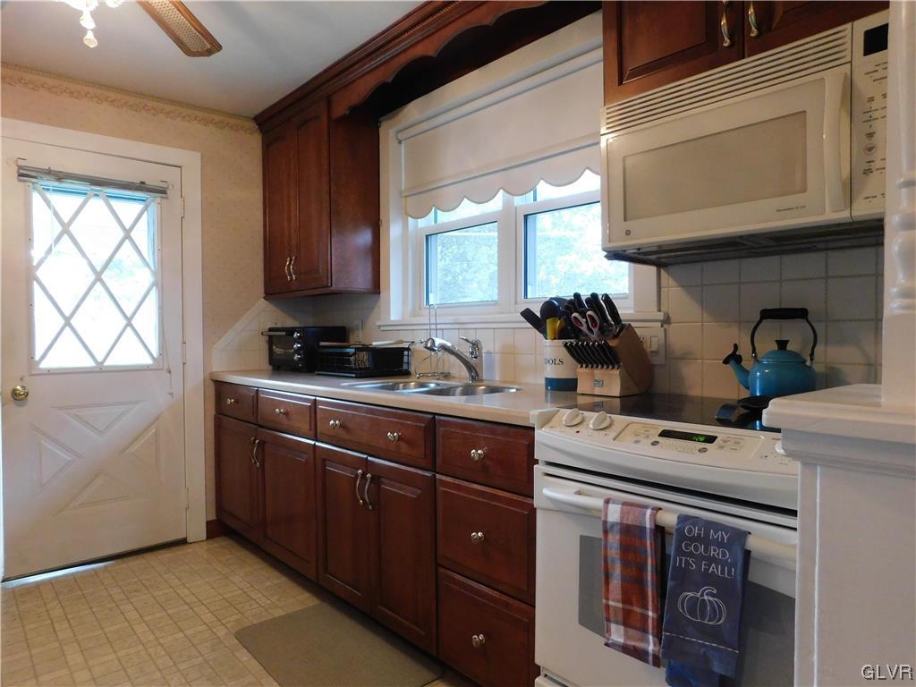 103 Fairview Avenue Wind Gap, PA 18091 - Photo 7 of 22 a kitchen with stainless steel appliances granite countertop a stove a sink and a microwave