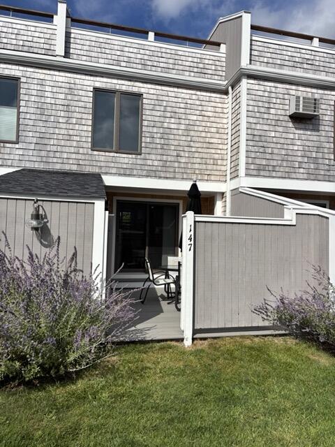 500 Ocean Street, Unit 147 Hyannis, MA 02601 - Photo 16 of 23 a view of a house with backyard and a chair