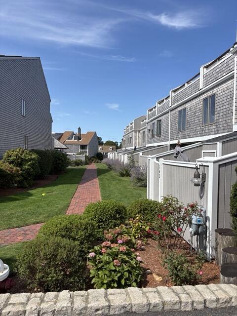 500 Ocean Street, Unit 147 Hyannis, MA 02601 - Photo 19 of 23 a backyard of a house with lots of green space