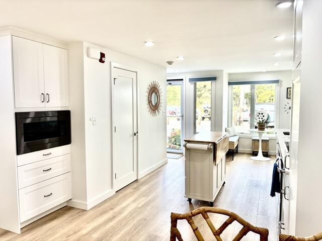 500 Ocean Street, Unit 147 Hyannis, MA 02601 - Photo 2 of 23 a living room with furniture a flat screen tv and large window