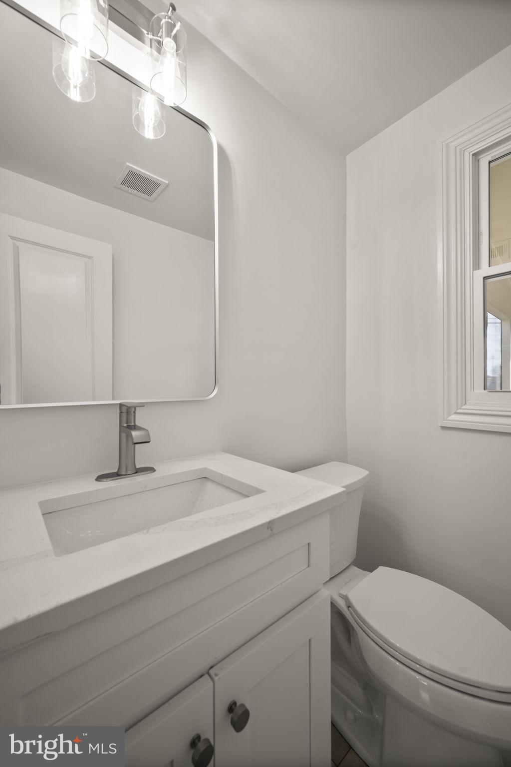 2111 Eastridge Road Lutherville-Timonium, MD 21093 - Photo 26 of 45 a bathroom with a sink a toilet and mirror