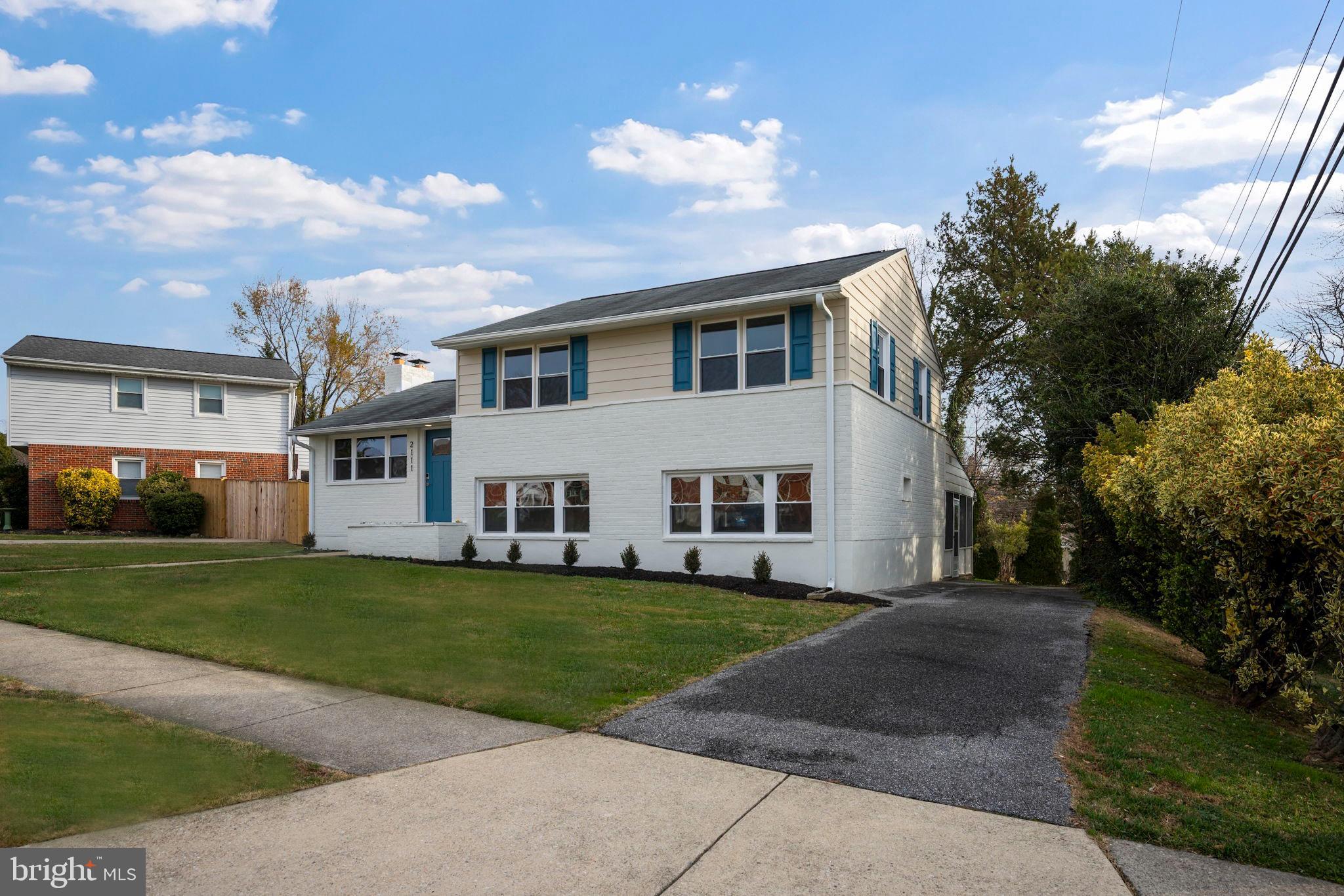 2111 Eastridge Road Lutherville-Timonium, MD 21093 - Photo 36 of 45 a view of a white house with a big yard and large trees