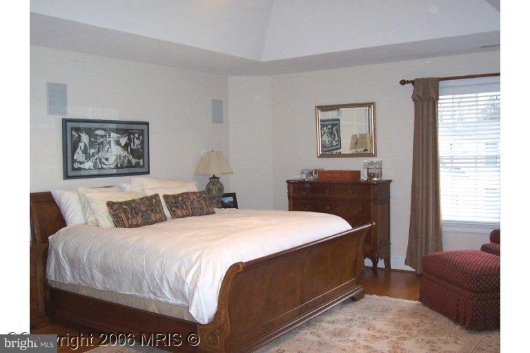 4416 Ridge Street Chevy Chase, MD 20815 - Photo 11 of 20 a bedroom with a bed and a couch