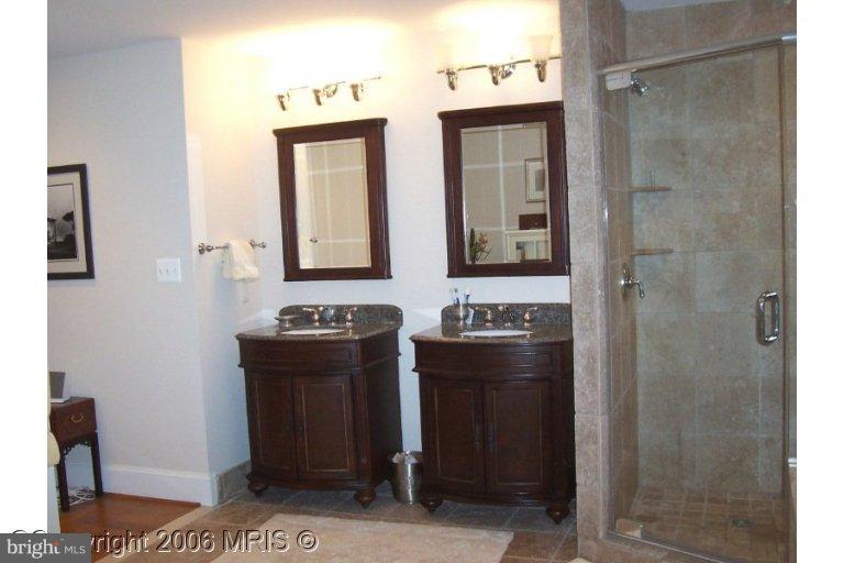 4416 Ridge Street Chevy Chase, MD 20815 - Photo 13 of 20 a bathroom with a sink a toilet and mirror