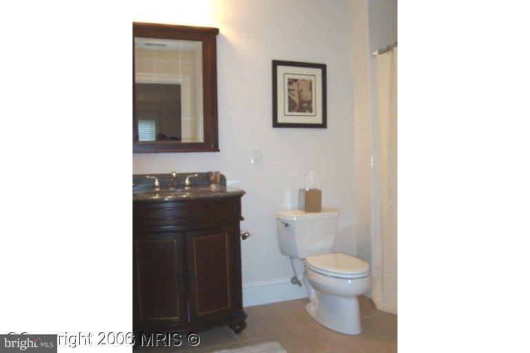 4416 Ridge Street Chevy Chase, MD 20815 - Photo 16 of 20 a bathroom with a toilet and a sink