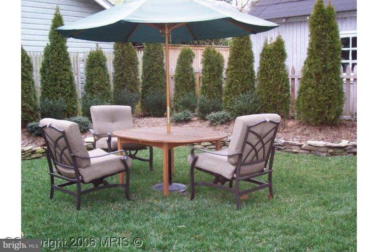 4416 Ridge Street Chevy Chase, MD 20815 - Photo 20 of 20 a view of a chair and table in the back yard