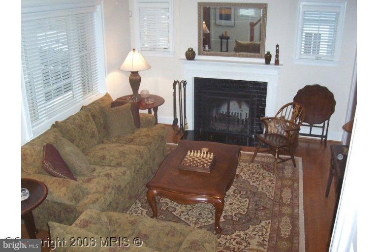 4416 Ridge Street Chevy Chase, MD 20815 - Photo 3 of 20 a living room with furniture and a fireplace