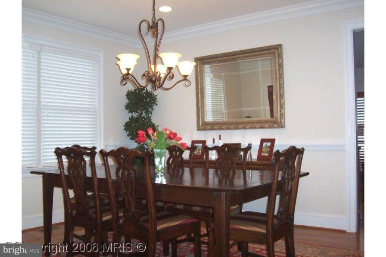 4416 Ridge Street Chevy Chase, MD 20815 - Photo 9 of 20 a view of a dining room with furniture and chandelier