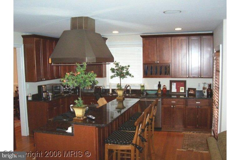 4416 Ridge Street Chevy Chase, MD 20815 - Photo 10 of 20 a kitchen with a table and chairs in it