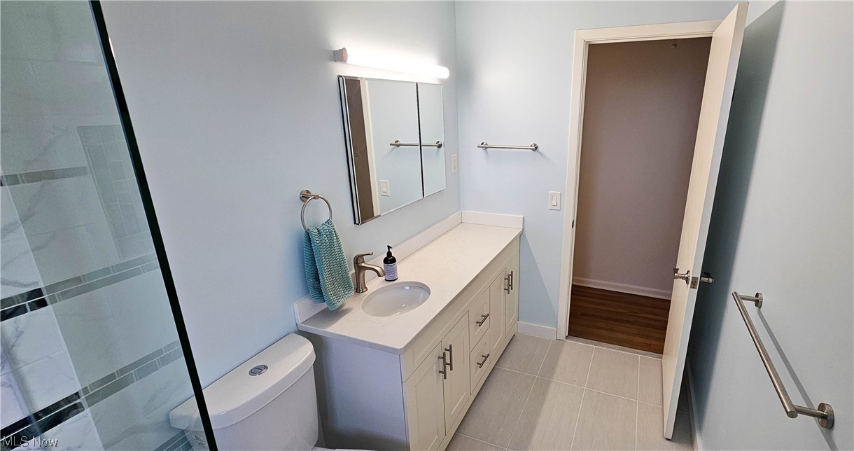 19755 Upper Terrace Road Euclid, OH 44117 - Photo 12 of 38 Bathroom featuring a tile shower, toilet, vanity, and tile flooring