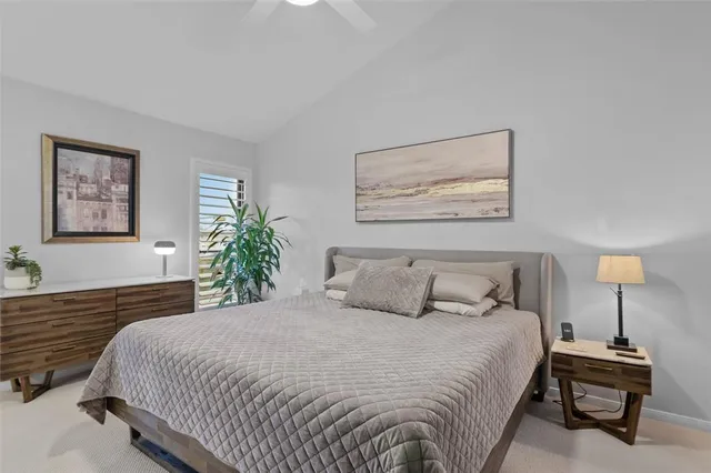 a bedroom with a bed and a lamp on table