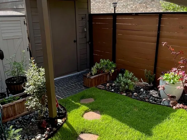 a view of a backyard with potted plants