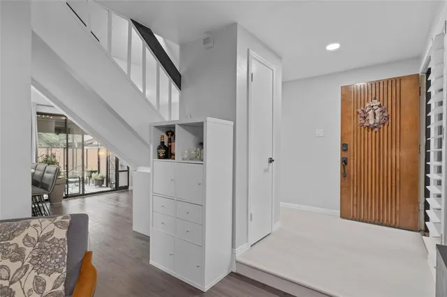 a view of entryway and hall with wooden floor