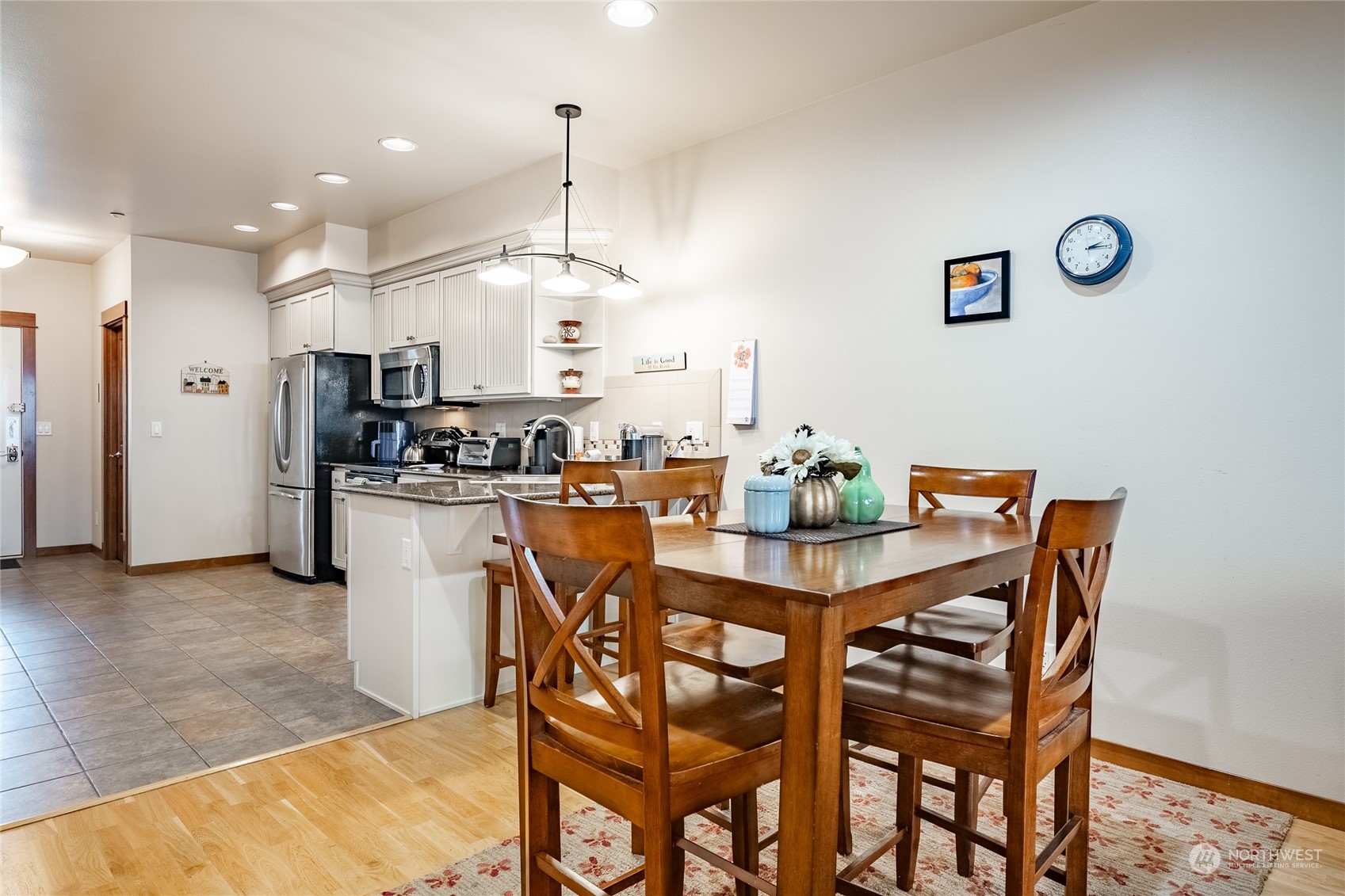7714 Birch Bay Drive, Unit 203 Blaine, WA 98230 - Photo 11 of 25 a dining room with kitchen island stainless steel appliances a dining table chairs and couches