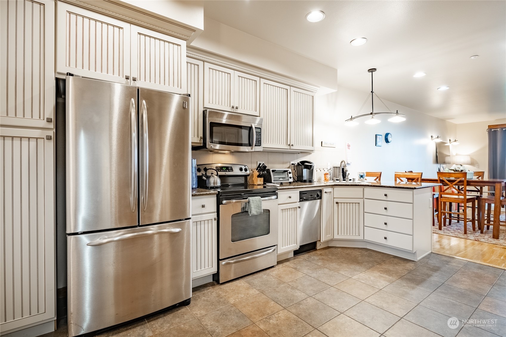 7714 Birch Bay Drive, Unit 203 Blaine, WA 98230 - Photo 8 of 25 a kitchen with white cabinets stainless steel appliances and a refrigerator