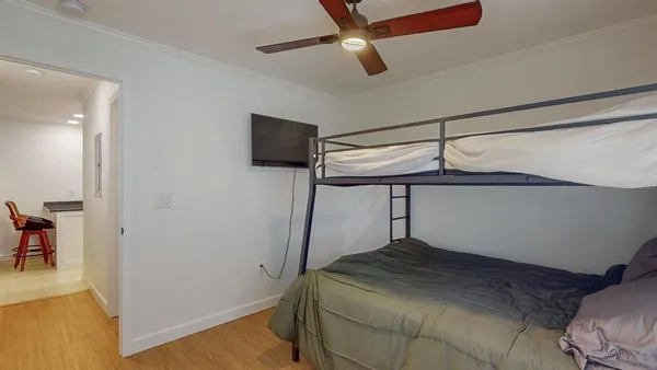 a bedroom with a bed and a chandelier