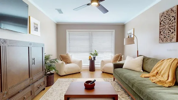 a living room with furniture and wooden floor